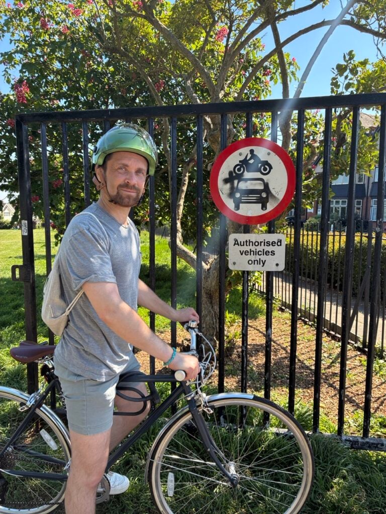 Stuart Allen on bike at gates